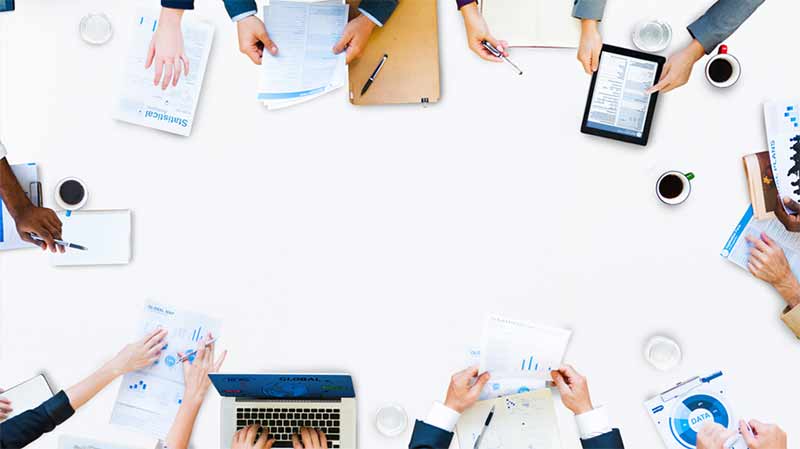 over head shot of people working around a desk