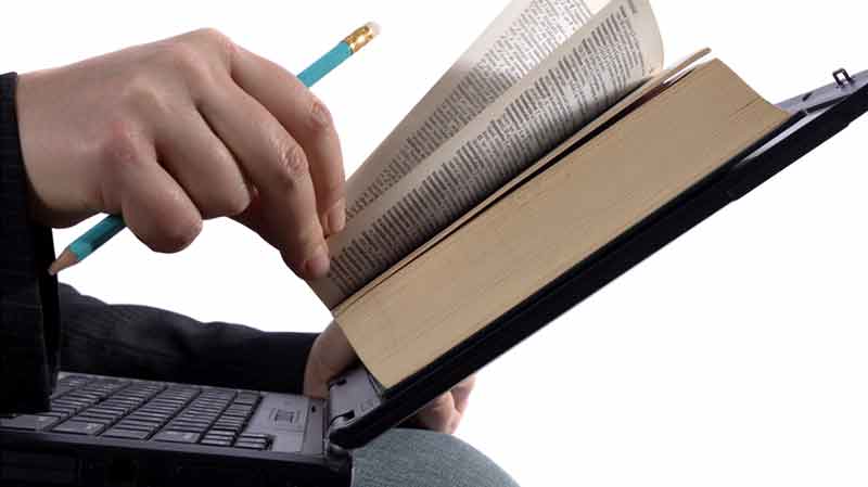 a book being rested on a laptop screen