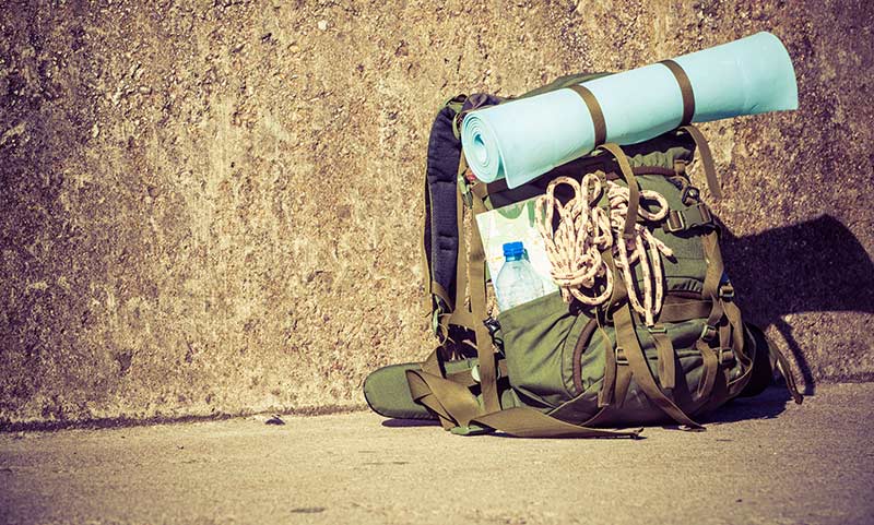 backpack leaning against a wall