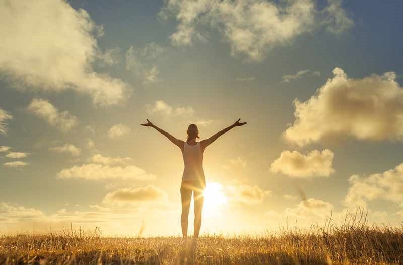 woman standing with arms outstretched