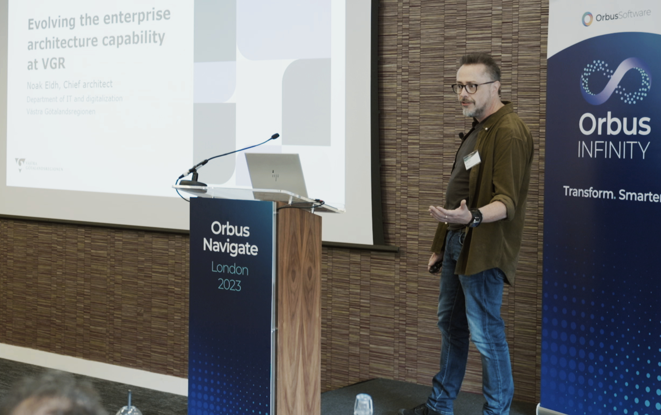 Photograph of a man from Västra Götalandsregionen presenting at Orbus Navigate customer event